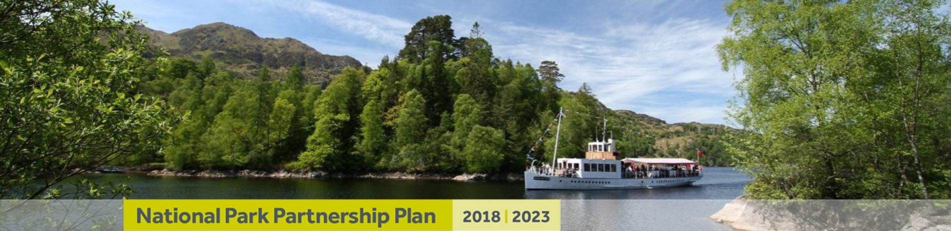 steampship-crossing-the-waters-of-loch-katrine-on-sunny-summer-day-with-text-banner-underneath-reading-national-park-partnership-plan-two-thousand-eighteen-two-thousand-twenty-three