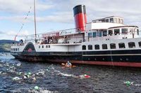 great-scottish-swim-in-loch-lomond-dozens-of-swimmers-wearing-coloured-caps-swim-next-to-maid-of-the-loch-steamship