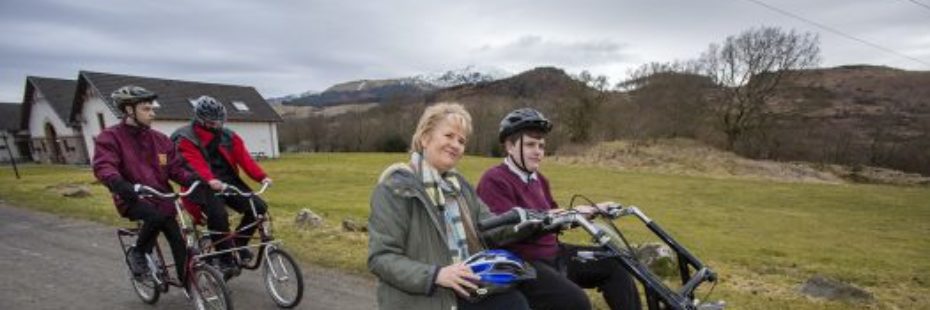 roseanna-cunningham-environment-secretary-on-special-bike-with-three-wheels-alongside-pupils-from-special-needs-school-at-photocall-for-launch-of-national-park-partnership-plan