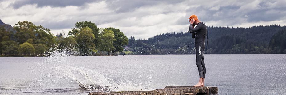 man-in-wetsuit-on-pier-preparing-to-jump-in-loch-ard