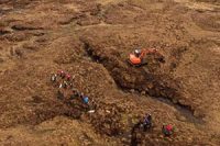 aerial-view-of-peatland-expanse-excavator-and-group-of-people