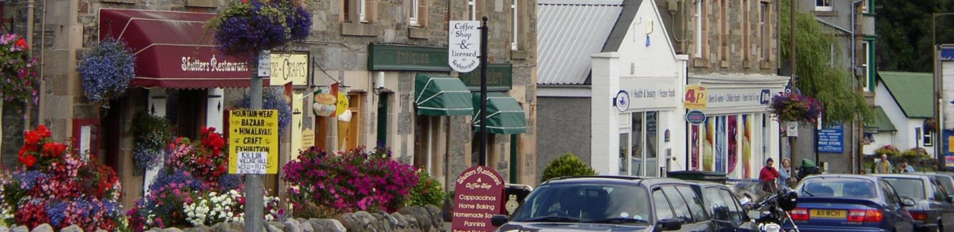 main-street-killin-colourful-shops-flower-outside-cars-parked-alongside