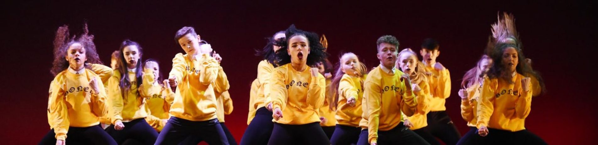 urbaniks-dance-troup-young-people-in-yellow-tops-dancing-vigorously