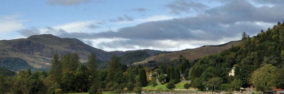 callander-meadows-and-ben-ledi-mountain-towering-above-on-left-native-woods-visible-around-picture
