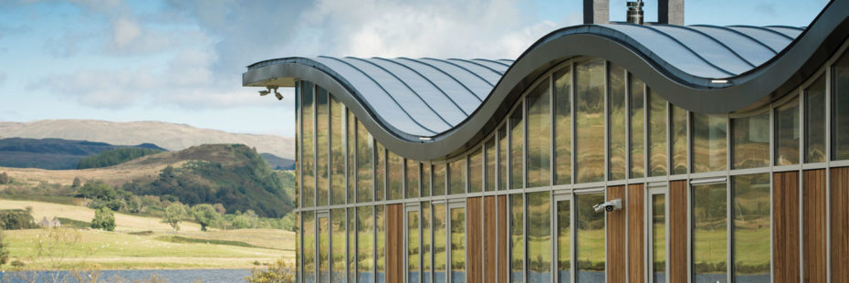 ripple-retreat-modern-glass-and-steel-building-with-undulated-roof-on-loch-venachar-shore-with-forested-hills-in-the-background