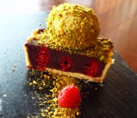 chocolate-raspberry-tart-on-brown-wooden-board