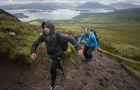 group-of-young-people-with-teachers-climbing-conic-hill-in-the-drizzle