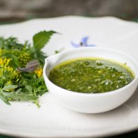 light-green-nettle-pesto-in-white-bowl-on-table