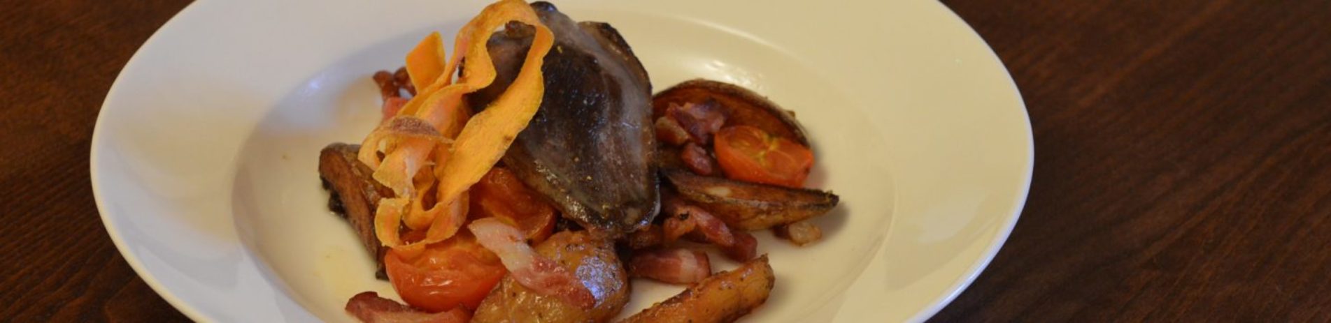 cooked-pigeon-on-white-plate-on-table