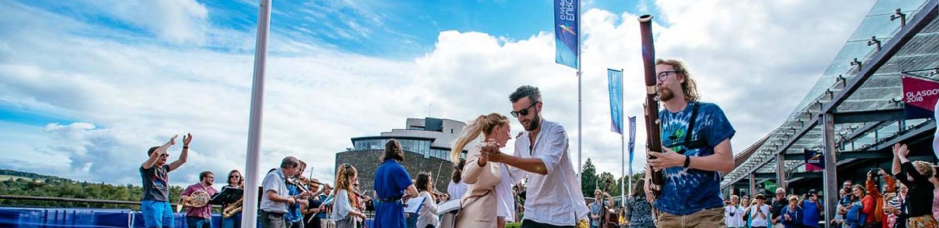 couples-dancing-surrounded-by-people-playing-instruments-and-crowds-cheering-at-lomond-shores-during-balloch-festival-two-thousand-eighteen