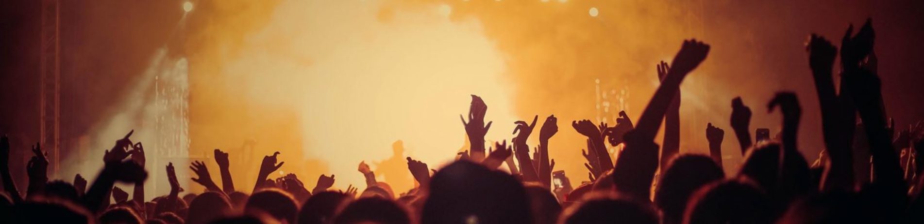 music-festival-atmosphere-orange-lights-and-steam-and-large-crowd-with-hands-up
