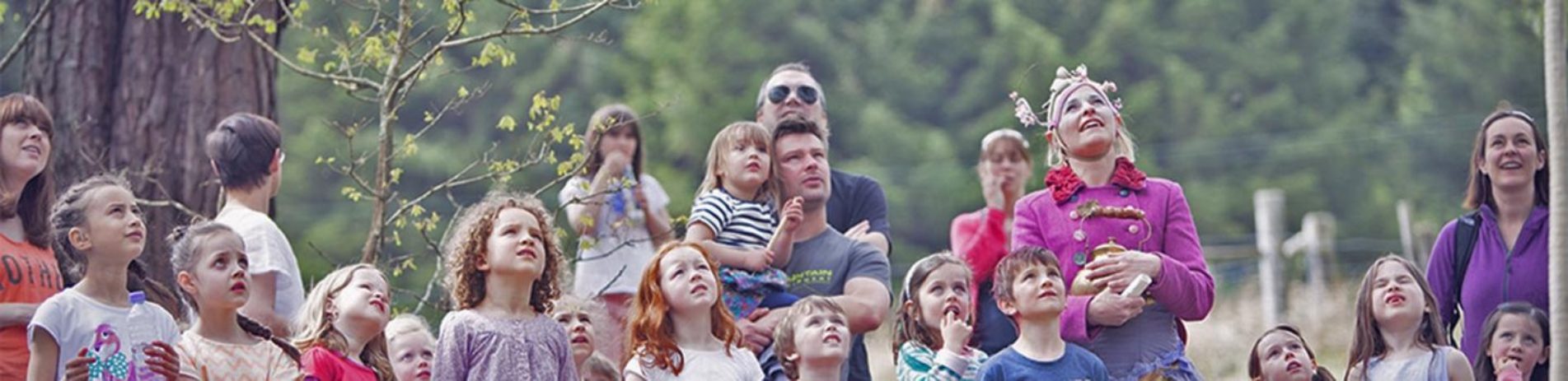 young-children-and-a-few-parents-all-looking-up-curious-mhor-festival