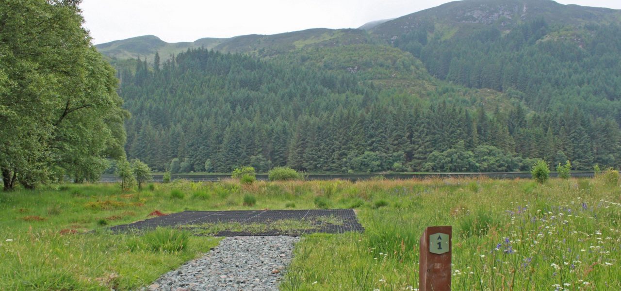 loch-chon-campsite-pitch-number-one-rubber-mat-for-pitching-tent-with-stunning-view-of-loch-and-coniferous-forest-on-hill-behind