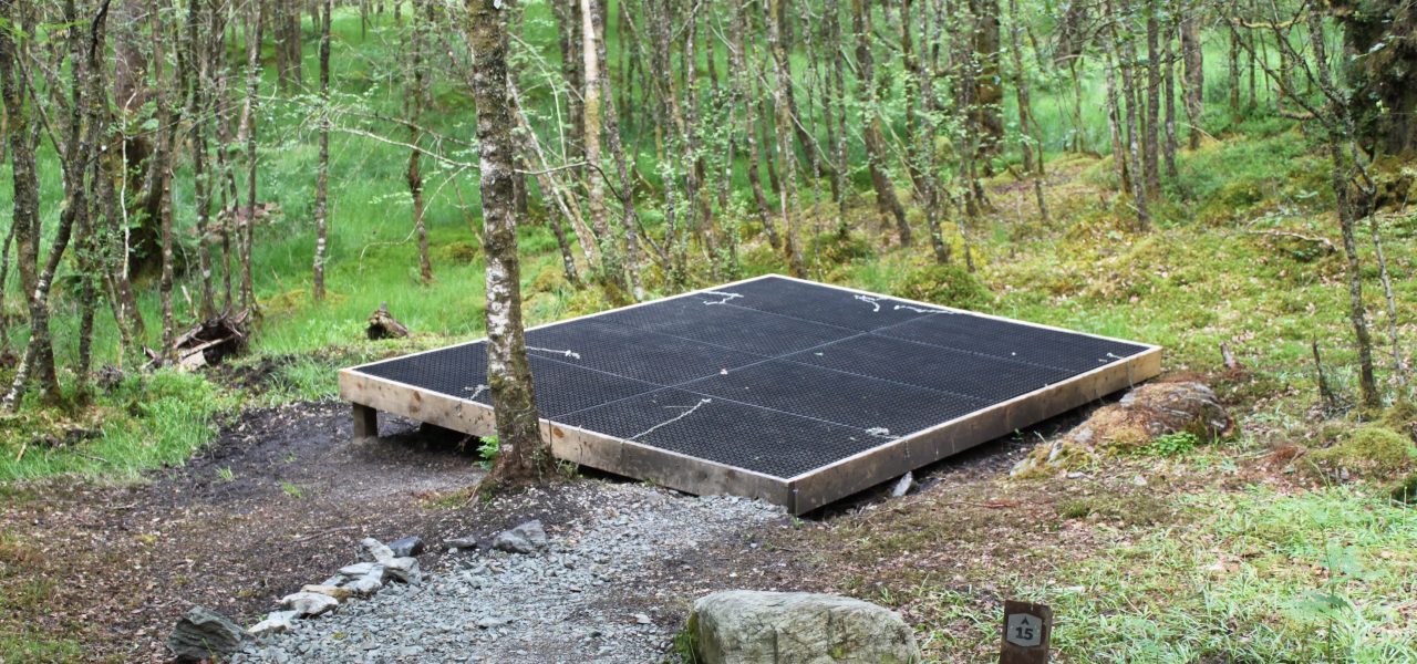 loch-chon-campsite-pitch-number-fifteen-rubber-mat-for-pitching-tent-on-wooden-platform-surrounded-by-young-trees