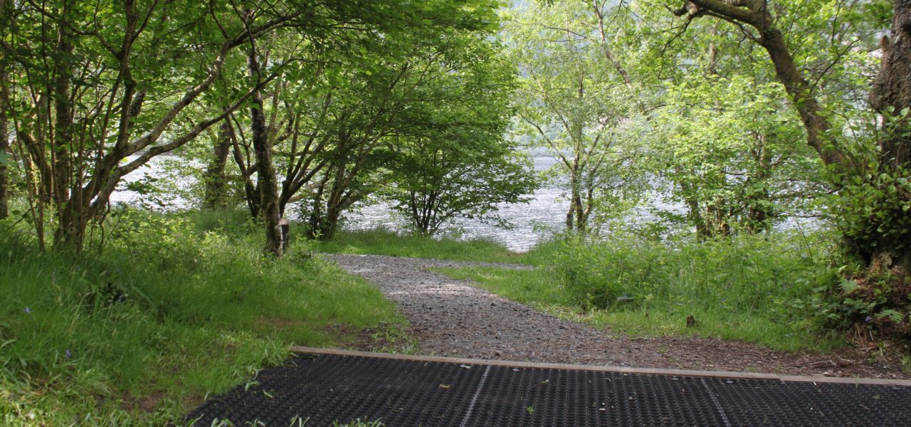 loch-chon-campsite-pitch-number-twenty-three-rubber-mat-for-pitching-tent-with-loch-visible-behind-young-trees