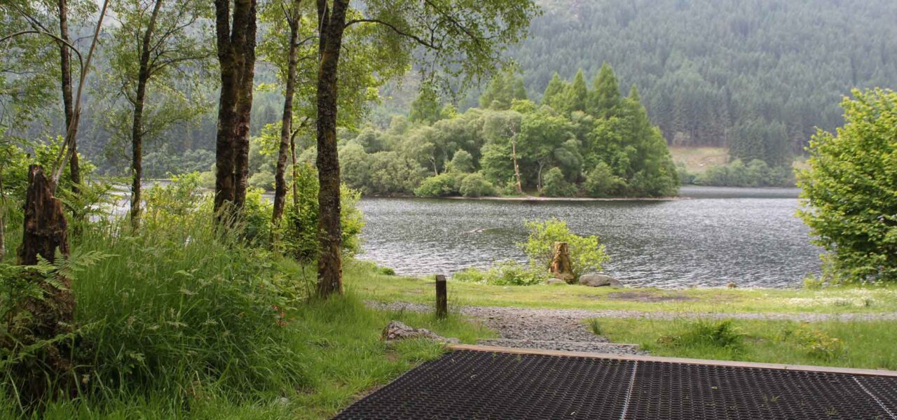 loch-chon-campsite-pitch-number-twenty-four-rubber-mat-for-pitching-tent-with-stunning-view-of-loch-chon-its-wooded-islands-and-forests-beyond