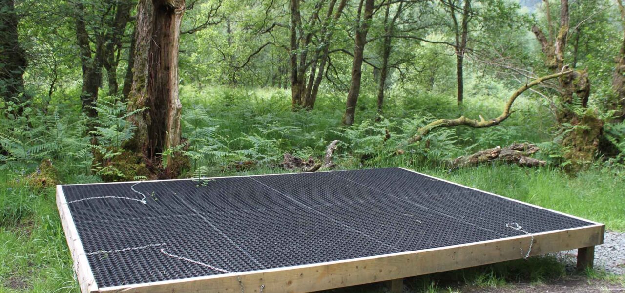 loch-chon-campsite-pitch-number-seven-rubber-mat-for-pitching-tent-on-raised-wooden-platform-surrounded-by-young-trees