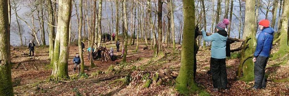 youth-residential-event-young-children-in-the-woods-doing-bushcraft-activities-its-winter-or-autumn-season-and-the-trees-are-bare-and-children-dressed-warmly-with-coats-and-hats-on