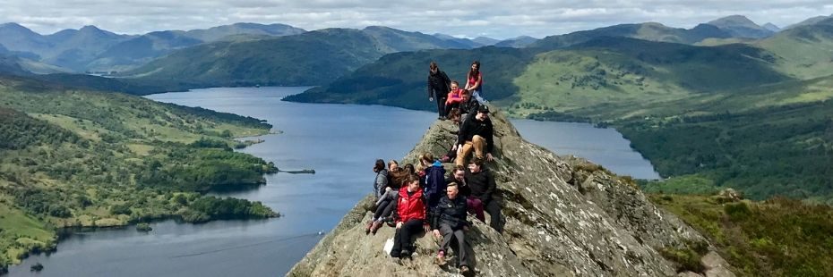 junior-rangers-with-national-park-education-officers-on-ben-aan-summit-with-sweeping-views-around-of-loch-katrine-and-the-trossachs-hills