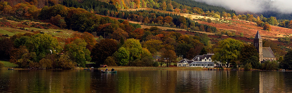 lake-of-menteith-in-autumn-with-boat-hotel-and-church-in-the-distance