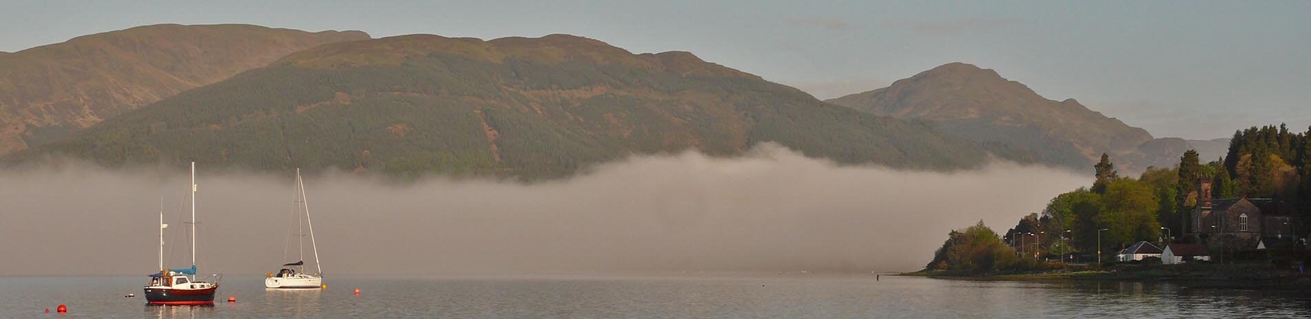 view-of-holy-loch-and-kilmun-village-and-shore-with-high-hills-in-the-distance