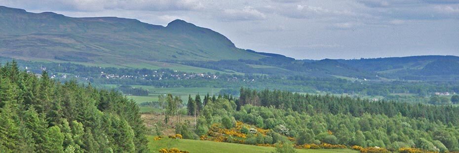 view-of-dumgoyne-hill-over-garadhban-forest-with-village-in-the-distance-on-the-left