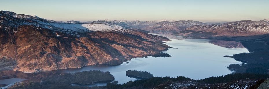 aerial-view-of-trossachs-mountains-covered-by-snow-on-summits-and-loch-katrine-taken-from-ben-aan
