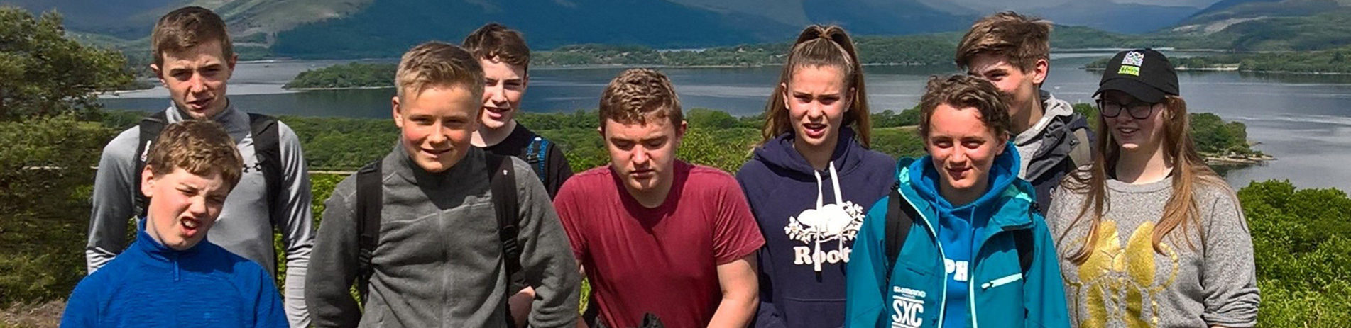 group-of-nine-young-people-on-a-summers-day-taken-in-front-of-loch-lomond