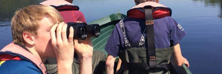 young-boy-with-auburn-hair-looking-through-binoculars-on-a-boat