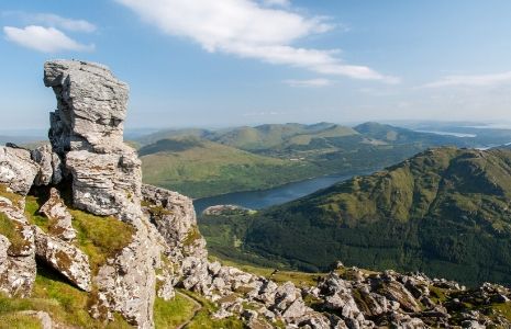 loch lomond day visit summit-of-cobbler-mountain-with-stunning-views-over-loch-lomond-and-surrounding-hills-and-with-the-needle-a-rock-chimney-prominent-on-left-of-picture