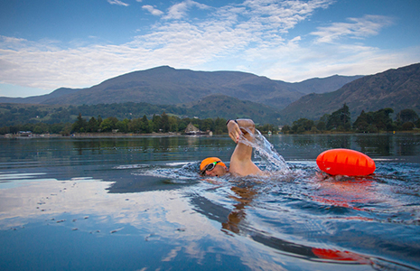 man-swimming-in-loch-with-buoyancy-aid