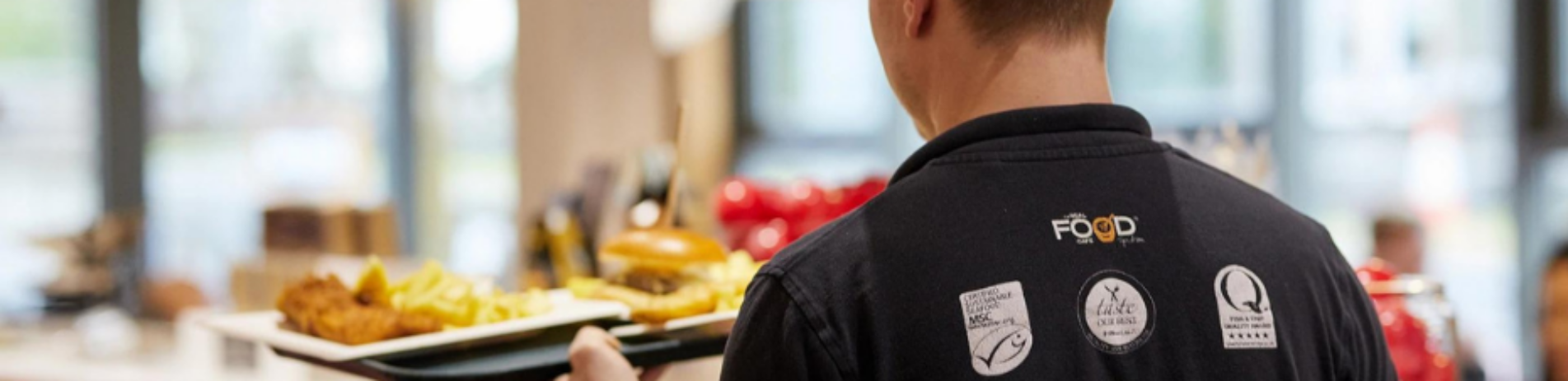 man serving chips in the Real Food Cafe in Tyndrum