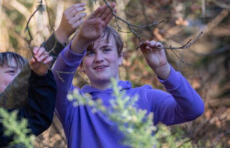 Hero-three-children-looking-at-tree-branches-with-a-National-Park-Ranger.jpg