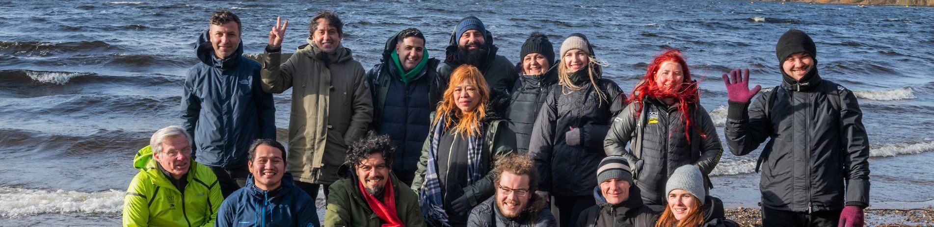 Group of people standing on shore of Loch Lomond