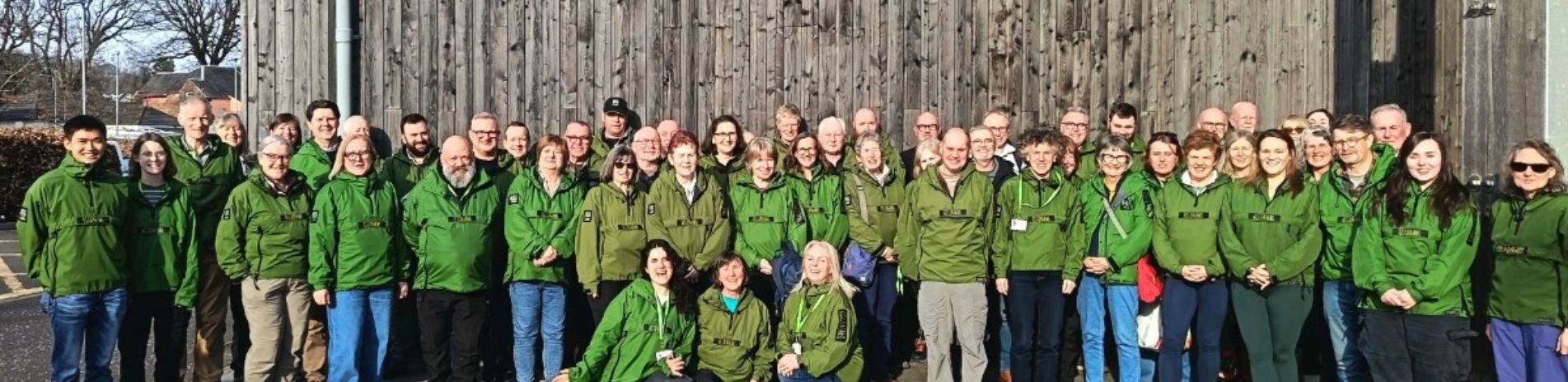 A group of volunteers pose in front of National Park Headquarters